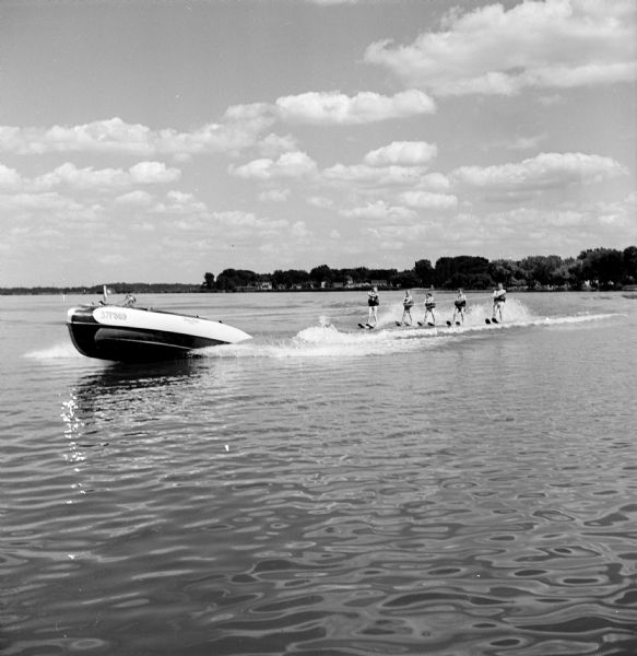 Ed Feiler towing his five youngsters on water skis across Monona Bay.