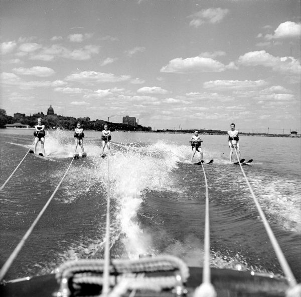 The five Feiler youngsters are towed on their water skis behind the boat driven by their father, Ed, on Monona Bay.