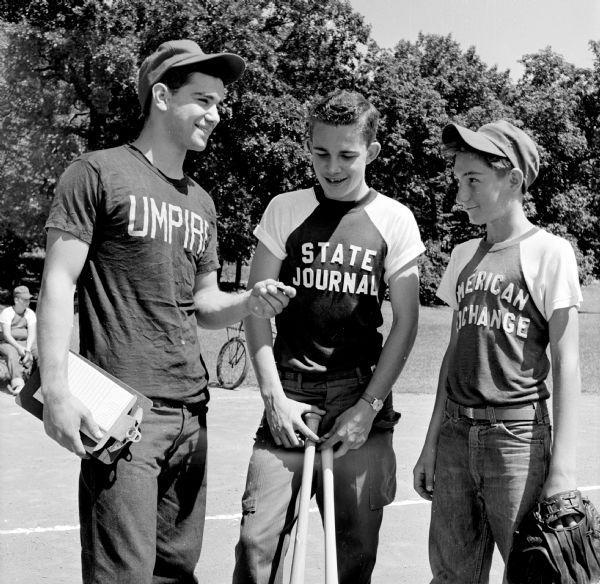 Umpire Paul Sergenian (left) discusses the game with youth baseball players, (shown left to right): Ronny Padloff and Jerry Riddle.