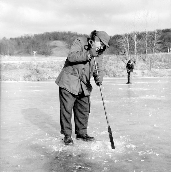 Harvey Gifford, of 2541 East Johnson Street in Madison, chops a hole in the ice on Salmo Pond near Back Earth in preparation for ice fishing, where he thinks "they'll be biting." The catch are rainbow trout.