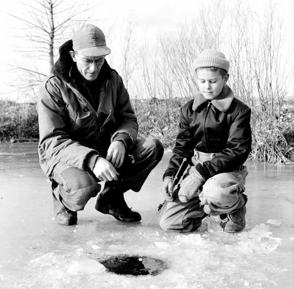Kenneth Kruse, a Madison policeman living at 5009 Flambeau Road, and his son Billy wait patiently for a nibble while ice fishing on Salmo Pond near Black Earth.