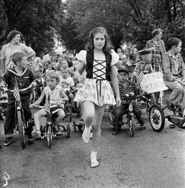 Mary Pauck is the drum majorette in charge of leading the Westmorland parade on the Fourth of July. The parade ended at the shelter house where all the children received refreshments.