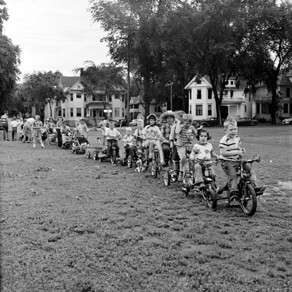 Decorated "units" stand in a line awaiting a children's parade at Conklin Park. The parade was arranged as part of the Board of Education's Recreation Division summer program.