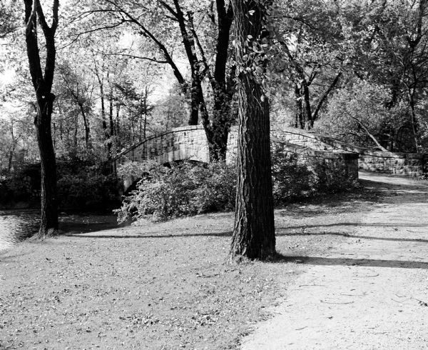 A gravel path leads to a bridge in Tenney Park.