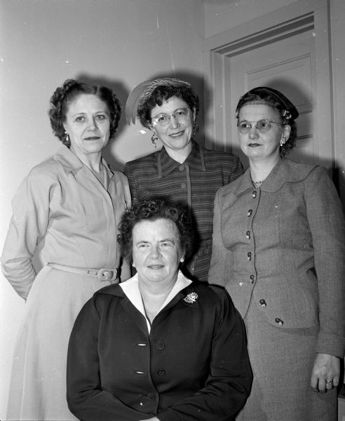 Four elected officers of the Dane County Association of Health Councils posing for a group portrait before planning a spring county-wide health survey. Standing in back are, (left to right): Mrs. E.H. Scott, treasurer; Mrs. C.O. Scott, first vice-president; and Mrs. Walter Mueller club secretary. Sitting in front is Mrs. Edwin Blaney, president.
