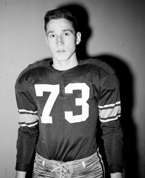 Portrait of John A. Hill, East High School football player, in uniform.