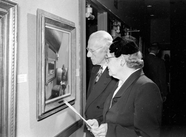 William and Annie Hussey, members of the Madison Art Association, view one of 42 paintings from the IBM collection on exhibit.