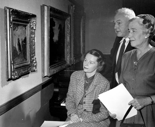 Members view an equestrian painting in the Madison Art Association's exhibit of American paintings between 1720 and 1920. They include, left to right, Noel Sterling, Prof. J.E. Mack, and Elizabeth Norris.