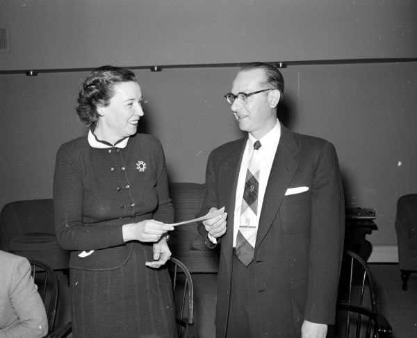 W.P. O'Brien, representing the DuBois Company of Cincinnati, presenting a check for $200 to Martha Study, president of the Wisconsin Dietitians Association, for a scholarship for a dietetics student. The Association was holding a state meeting at the University of Wisconsin.
