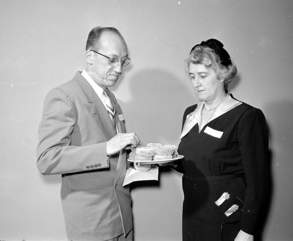 Walter and Marion Krause sample doughnuts at a meeting held for 120 Madison and Dane County foster parents at Gardener's Baking Company. The men have cared for more than 200 foster children in their 17 years of service.