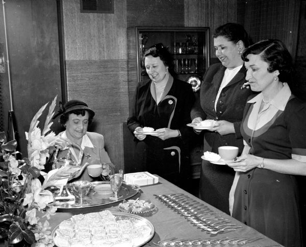 Flora Steul serves tea following a meeting in which final arrangements were made for the West District Round-Up of Girl Scouts held on May 7th. Girl Scout leaders waiting to be served are, left to right: Mrs. Ray Fincher, Mazomanie; Beatrice O'Connor; and Ethel Alt.