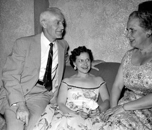 Oscar and Harriet Block chatting with Jane Deuel, (center) at the spring dinner dance of the Cosmos Dancing Club at the Nakoma Country Club.