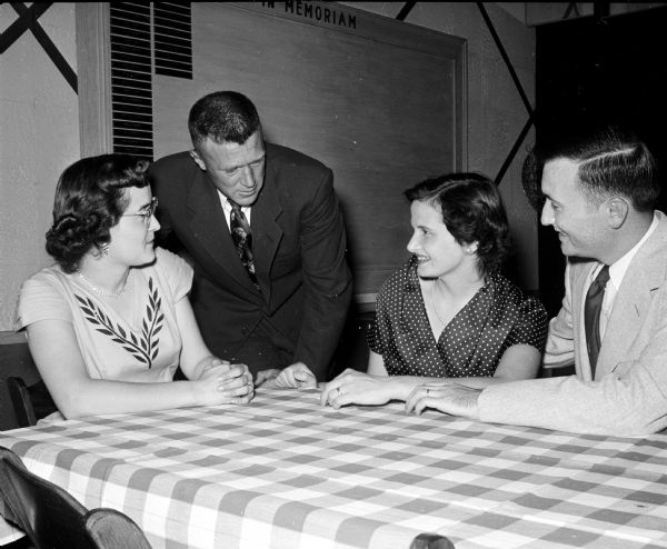Members of the Edgewood High School Class of 1945 converse during dinner at the class reunion dinner dance at the Elks' Club. They include, from left to right: Mr. and Mrs. Marian Kraak and Rita and Paul Coyle.