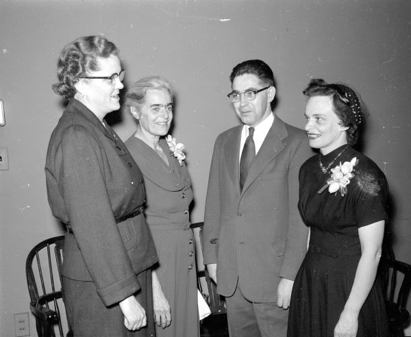Aldyth Lange (left), Elizabeth Rauschenbush, and William and Clarice Wilmot attend a banquet celebrating Phi Delta Gamma's 25th anniversary and Founder's Day. Professor Wilmot was the guest speaker for the event and the subject of his speech was "Big Business — Where Do We Stand."