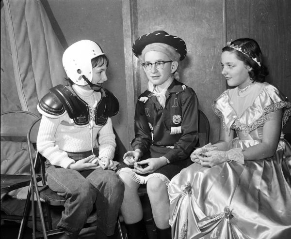 Ann Taylor (left), David McCaffery, and Joann Chrstianson attend a costume party for sixth graders of Jefferds dancing class.
