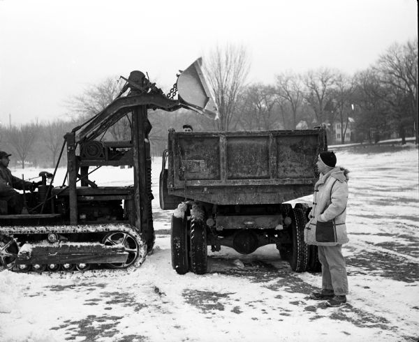 Hill captain Werner Schorr supervises the removal of snow in Vilas Park to transport to the Blackhawk Ski Club's Tomahawk Ridge for the upcoming jumping tournament.