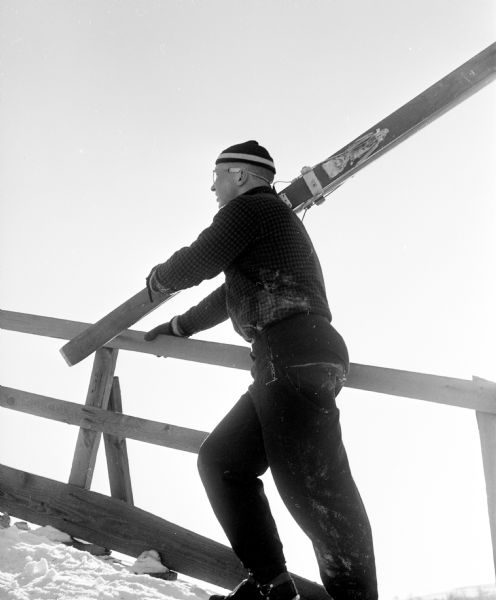 Frank Ticknor makes the long climb to the top of the ski jump during the Blackhawk Ski Club's annual jumping tournament at their Tomahawk Ridge site.