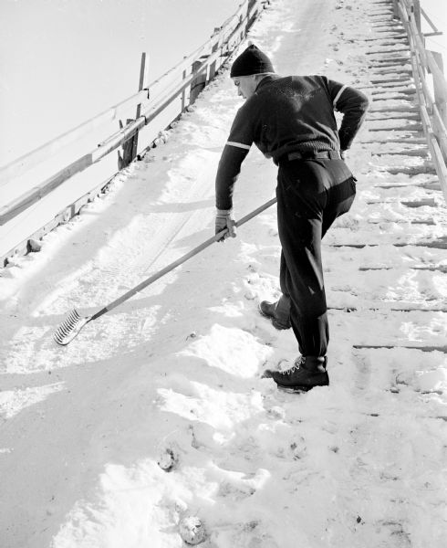 Hill captain Werner Schorr smooths snow near the base of the ski jump scaffold during the Blackhawk Ski Club's annual jumping tournament at their Tomahawk Ridge site.