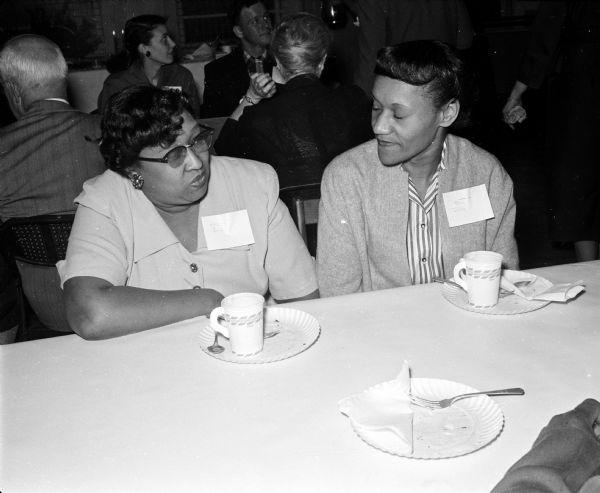 Among those attending a meeting at Neighborhood House, 768 West Washington Avenue, are Ina Doss, left, and Mrs. Armand Gardiner. The gathering was for neighborhood residents, board members of the Neighborhood House Association Auxiliary and Madison Neighborhood Centers and others interested in community problems.