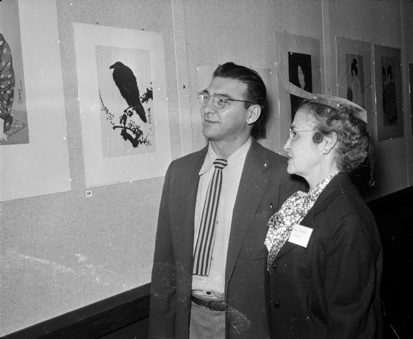 Santos Zingale, assistant professor of art education at the U.W., and  Louise Langer, wife of Prof. Rudolph Langer, owner of the collection, attend an exhibit of Japanese prints at the U.W. Memorial Library.