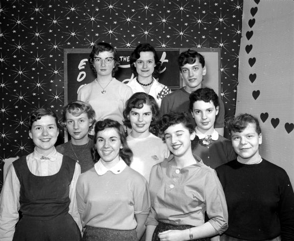 Group portrait of a newly-organized girls' chorus at the Loft Youth Center. They performed at the Center's 10th anniversary party.  Left to right, bottom row, Nancy Goodrich, Mary Lou Connery, Inge Schroeder, and Emily Gerothanas.  Middle row, Ellen Bubeck, Rose Marie Thuesen, and Pat Caparoon. Top row, Barbara Pepper, Kay Kessenich and Sharon Buchanan.