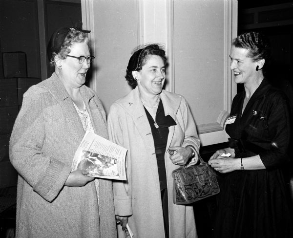 Lucile Sachse (right) greets two wives of Shriners as they register at the Hotel Loraine for the Midwest Shrine Convention in Madison. The guests are Mrs. O.G. Newborg and Mrs. Lester Hanke, both of Tomahawk, Wisconsin.