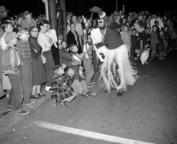 Children watch a clown with a snake at the parade during the Midwest Shrine Convention.