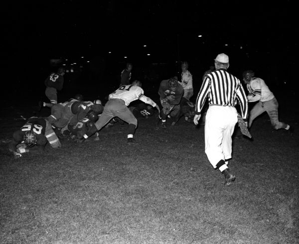 Eddie Hart of Kenosha scoring a touchdown during the University of Wisconsin freshman football game. Trying for the tackle is Jim Heindke (61) of Wisconsin Dells.