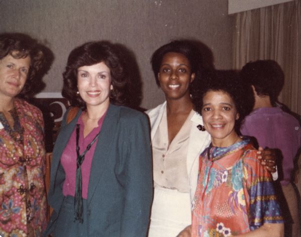 Indoor group portrait of Vel Phillips with three other women.