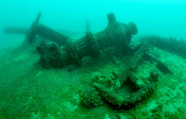 Underwater view of pieces of the schooner <i>Advance</i> laying on the haul of the ship at the bottom of Lake Michigan.