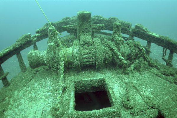 Underwater view of the windlass (on the bow of the ship) of the <i>Northerner</i>, which is covered by algae and mussels.