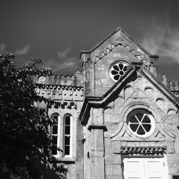 View looking up at the facade of the synagogue known as Gates of Heaven. This synagogue has been converted over last century from a synagogue, to the Unitarian Society, the Woman's Christian Temperance Union, and a funeral home. It is now a venue for weddings, celebrations, and some of the Jewish High Holy Days.