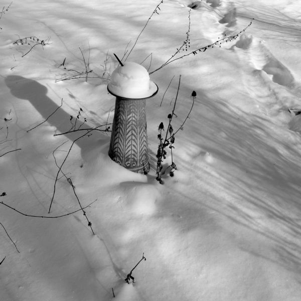 A sundial covered in snow.