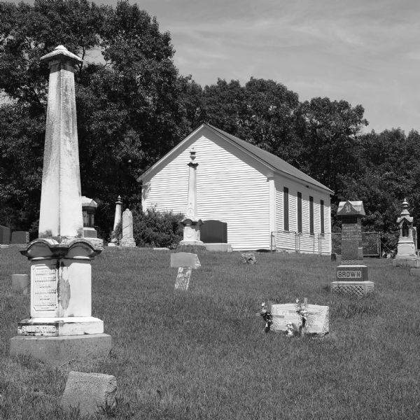 View across graveyard towards the Wee White Kirk, which was built in 1865 by settlers from Scotland. The church is located a short distance from Fountain Lake and the John Muir homestead.