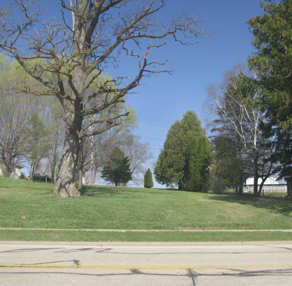 An empty lot, which is the former site of the Cornish Primitive Methodist Episcopal Church.
