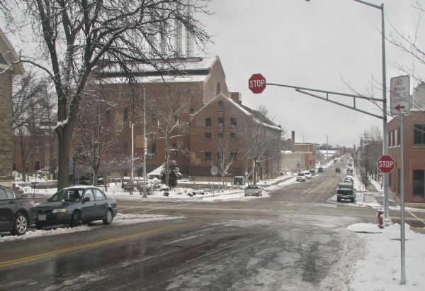 A view of the intersection of South Blair and East Main Streets, looking easterly. There is snow on the ground and the scene includes a number of brick buildings.
