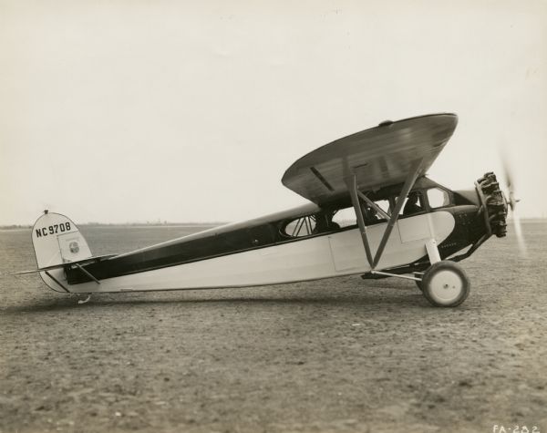Right side view of a Fairchild Model 71 sitting on a runway. The tail identifier reads: "NC 9708." 
