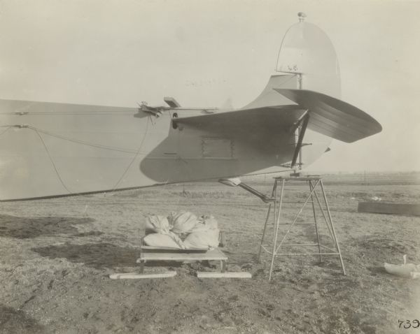 Side view of back of the fuselage and the tail of a Fokker Universal parked outdoors.