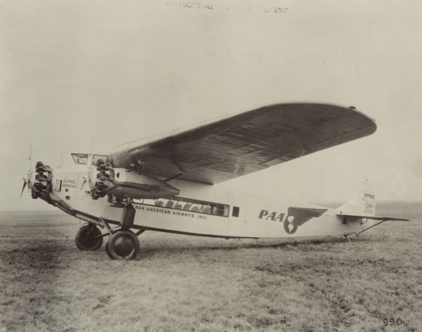 Left side view of a Fokker F-10 Super Trimotor sitting on a runway. The tail identifier reads: "9700." The airplane was owned by Pan American Airways Inc., and painted on the side is: "U.S. Mail," "Cuban Mail," "Pan American Airways Inc." The logo of Pan American Airways is painted on the fuselage near the tail.