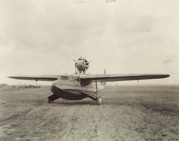 Three-quarter view from front left of a Fokker Amphibian model F-11 sitting on a runway.