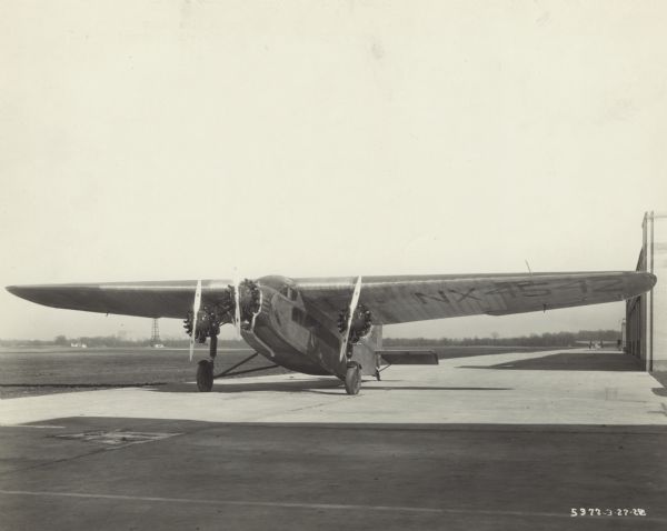 Front view of a Ford 4-AT-15 Trimotor, equipped with three Whirlwind engines, sitting on a runway. The wing identifier reads: "NX 4542." This airplane was one of three used in Richard Byrd's 1928 expedition to the South Pole. It was named "Floyd Bennett" after a recently deceased pilot that partook in Byrd's previous expeditions.