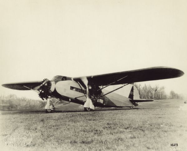 Three-quarter view of a Keystone K-78 "Patrician" sitting on a runway. The "Patrician" is a twenty-passenger monoplane powered by three Wright Cyclone engines. 