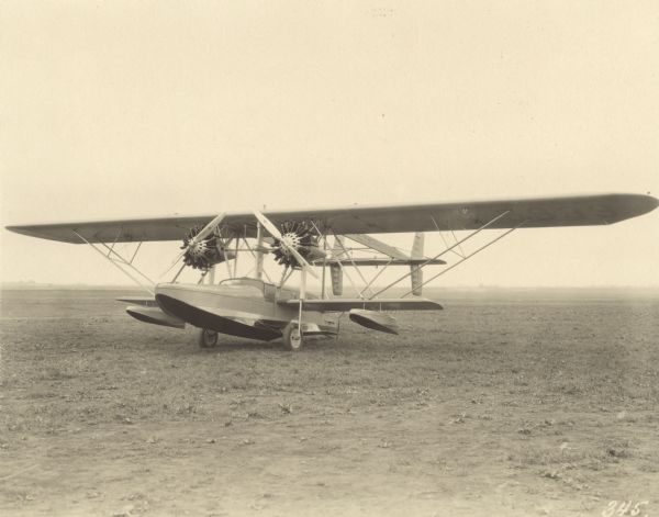 Three-quarter view from front left of a Sikorsky S-38A, an amphibious airplane powered by two 400 hp Pratt & Whitney Wasp engines, sitting on a runway. The wing identifier reads: "5933."
