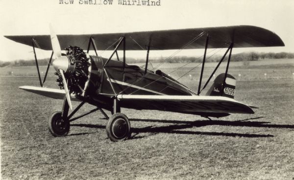 Three-quarter view from front left of a Swallow G-29 sitting on a runway. The tail identifier reads: "6099." This monoplane was powered by a 225 hp Wright J-5 Whirlwind engine.