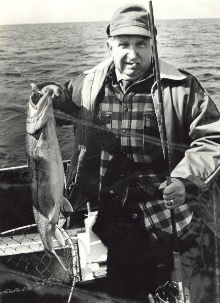 Sid Boyum holds a catch while out on Lake Michigan aboard a chartered fishing boat with Bay Charter Service out of Sturgeon Bay.