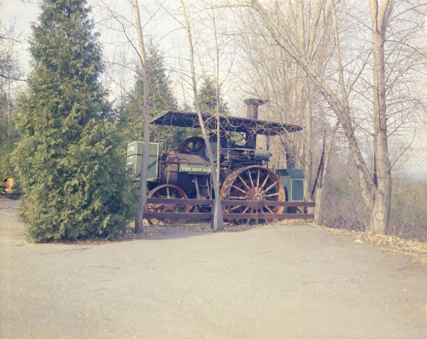 A steam-powered tractor sitting outdoors on the grounds of House on the Rock.