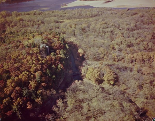 Aerial view of House on the Rock in the fall. The structures are partially hidden by trees.