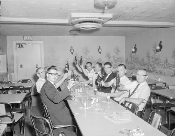 Sid and his friends celebrating at a restaurant after installing the roof for the pagoda in Sid's backyard. Russell Pratt Mecalf is 2nd from right raising a bottle of beer. On his right is possibly Al Able.