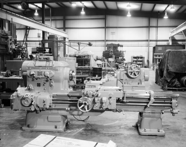 Several pieces of Gisholt machinery lined up on the factory floor.