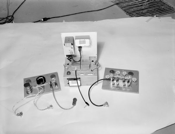 Display of three pieces of wiring for Gisholt machinery.